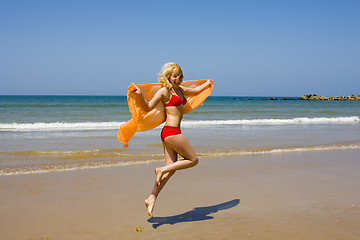 Image showing Girl runs on beach