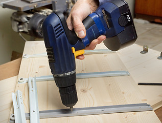 Image showing Fastening with an electric screwdriver furniture wooden parts