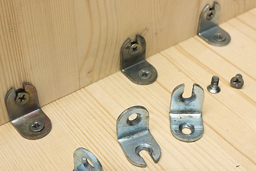 Image showing Fastening metal details at manufacturing wooden furniture