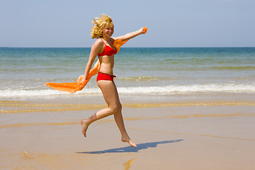 Image showing Girl runs on beach