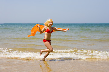 Image showing Girl runs on beach