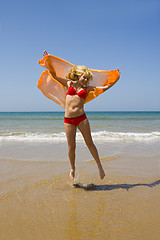 Image showing Girl runs on beach