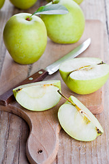 Image showing fresh green sliced apples and knife