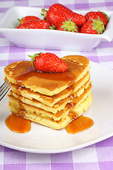 Image showing Stack of heart-shaped pancakes with syrup and strawberry