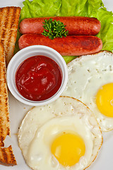Image showing Fried eggs with sausages