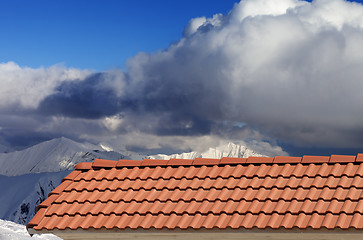 Image showing Roof tiles and snowy mountains