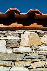 Image showing Wall built of stones. Sun light