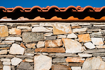 Image showing Wall built of stones. Sun light