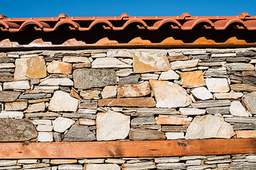 Image showing Wall built of stones. Sun light