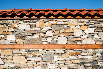 Image showing Wall built of stones. Sun light