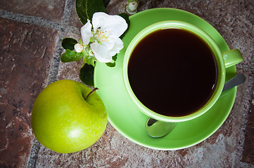 Image showing Cup of tea with an apple