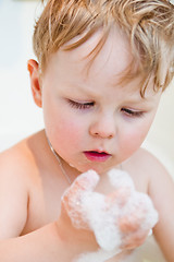 Image showing The little boy bathes in bathing with foam