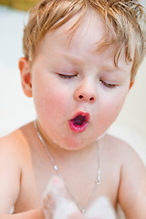 Image showing The little boy bathes in bathing with foam