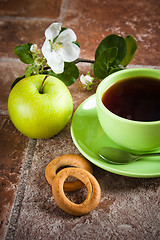 Image showing Cup of tea with an apple