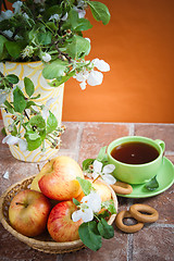 Image showing Cup of tea with an apple