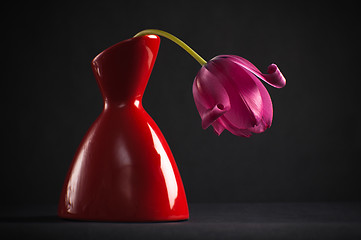 Image showing pink tulips in a vase on a black background 