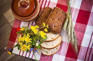 Image showing Still life with bread, flowers and pot