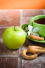 Image showing Cup of tea with an apple