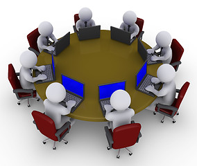 Image showing Businessmen around table with laptops