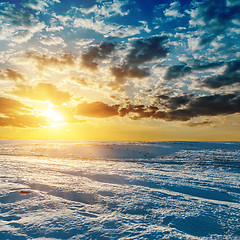 Image showing orange sunset over meadow in winter