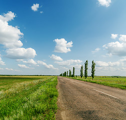 Image showing asphalt road in green landscape and blue sky