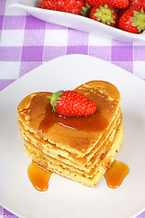 Image showing Stack of heart-shaped pancakes with syrup and strawberry