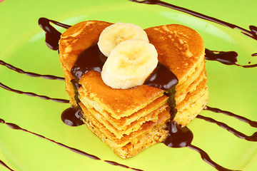 Image showing Stack of heart shaped pancakes with chocolate and banana