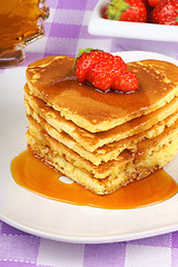 Image showing Stack of heart shaped pancakes with syrup and strawberry