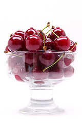 Image showing Ripe fresh cherry in the glass isolated on white background