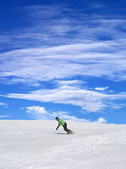 Image showing Snowboarder on ski slope and blue sky