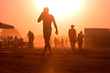 Image showing Golden sunset with many people