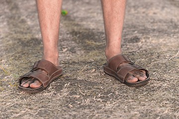 Image showing Feet of a sad farmer without crop