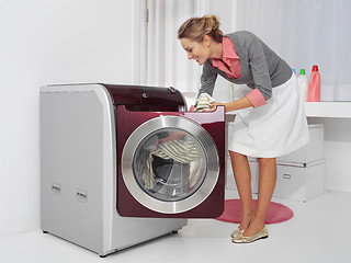 Image showing young woman doing laundry