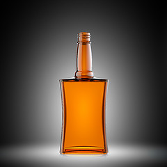 Image showing Empty red glass bottle for scotch or brandy