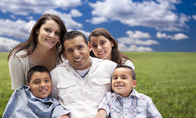 Image showing Hispanic Family Portrait Sitting in Grass Field