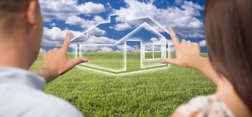 Image showing Couple Framing Hands Around House Figure in Grass Field