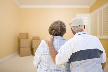 Image showing Senior Couple In Room Looking at Moving Boxes on Floor