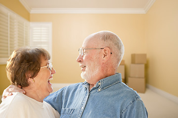 Image showing Happy Senior Couple In Room with Moving Boxes on Floor