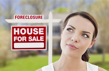 Image showing Mixed Race Woman In Front of House and Foreclosure Sign