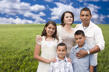 Image showing Hispanic Family Portrait Standing in Grass Field