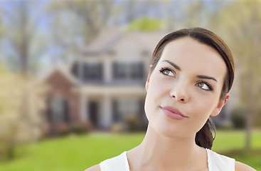 Image showing Thoughtful Mixed Race Woman In Front of House