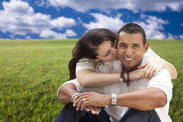 Image showing Hispanic Couple Sitting in Grass Field