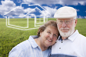 Image showing Senior Couple Standing in Grass Field with Ghosted House Behind