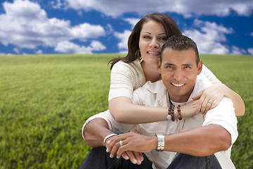 Image showing Hispanic Couple Sitting in Grass Field