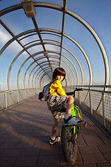 Image showing boy on a bicycle in the covered bridge