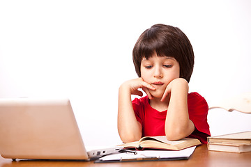 Image showing child reading a textbook