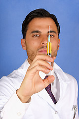 Image showing Doctor holding syringe