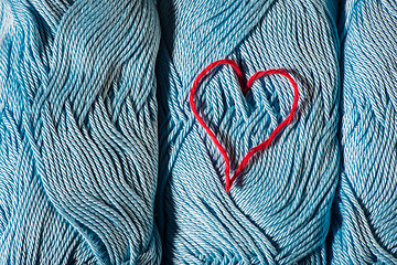 Image showing Knitted red heart on blue