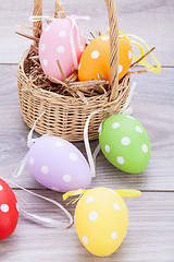 Image showing colorful easter egg decoration on wooden background