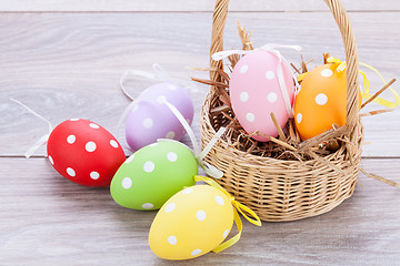 Image showing colorful easter egg decoration on wooden background